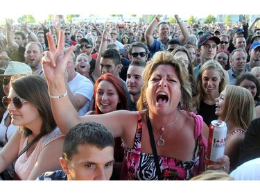Ethna Rigby (centre) was just one of thousands of screaming fans when Journey hit the main stage on day two of Bluesfest Friday, July 4, 2014 at LeBreton Flats, Ottawa.