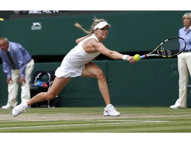 Eugenie Bouchard of Canada plays a return to Petra Kvitova of the Czech Republic during the women's singles final at the All England Lawn Tennis Championships in Wimbledon, London, Saturday, July 5, 2014.