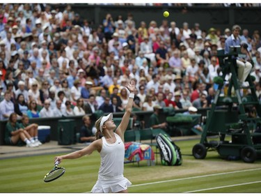 Eugenie Bouchard of Canada serves to Petra Kvitova of Czech Republic during the women's singles final at the All England Lawn Tennis Championships in Wimbledon, London, Saturday, July 5, 2014.
