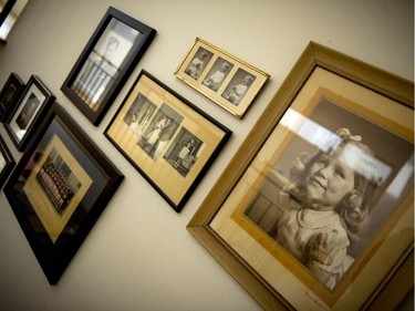 A wall of vintage family photos gives this new house layers of history.