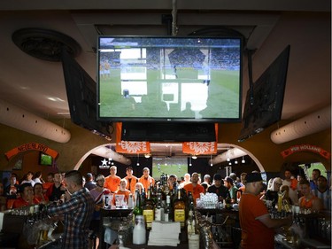 Fans cheering for Netherlands watches the FIFA World Cup 2014 match between Netherlands and Argentina at Hooley's on Wednesday, July 9, 2014.