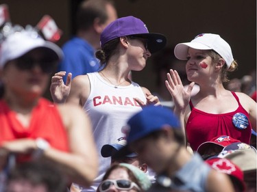 Fans dance in the stands to celebrate Canada Day during interleague baseball action between the Toronto Blue Jays and Milwaukee Brewers in Toronto on Tuesday July 1 , 2014.