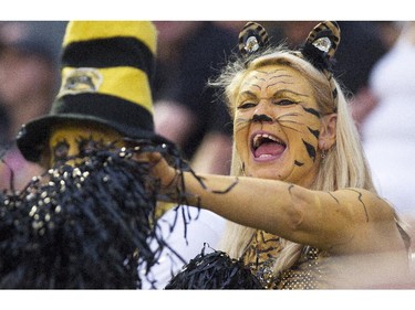 Hamilton Tiger-Cats fans cheer on their team as they take on the Ottawa RedBlacks during their CFL season home opener in Hamilton, Ont., Saturday, July 26, 2014.