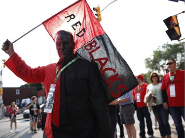 Fans of all categories, Rick Loveless among them, marched down Bank Street and into the stadium grounds before the Redblacks' home opener at TD Place on Friday, July 18, 2014.