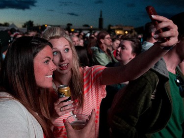 Fans of "The Killers" Courtney Luce and Sarah Milchak grab a selfie while waiting for the band to go on the Bell Stage at Bluesfest.