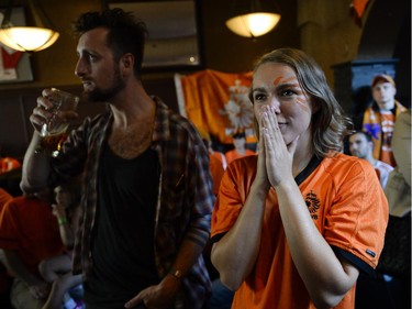 Fans react as they watch the FIFA World Cup 2014 match between Netherlands and Argentina at Hooley's on Wednesday, July 9, 2014.