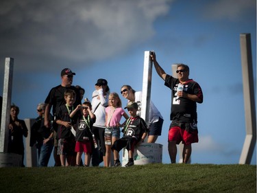 Fans stands along the east end of the field during the official opening of TD Place at Lansdowne Wednesday July 9. 2014.