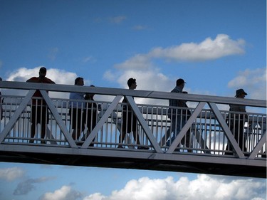 Fans walks across the foot bridge at the official opening of TD Place at Lansdowne Wednesday July 9. 2014.