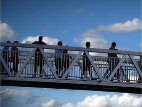 Fans walk across the footbridge at the official opening of TD Place at Lansdowne Wednesday July 9. 2014.