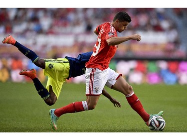 Benfica's Swiss defender Loris Benito (R) vies Ajax's defender Ruben Ligeon (L) during the Eusebio Cup football match between Benfica and Ajax at Luz Stadium in Lisbon, on July 26, 2014.