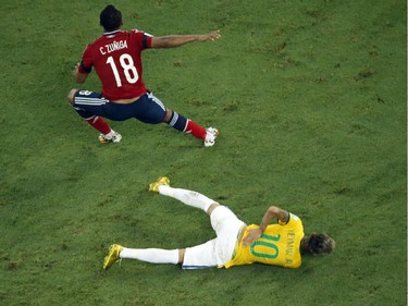 Brazil's forward Neymar reacts on the ground after being injured following a foul by Colombia's defender Juan Camilo Zuniga (L) during the quarter-final football match between Brazil and Colombia at the Castelao Stadium in Fortaleza during the 2014 FIFA World Cup on July 4, 2014. Brazil star Neymar was ruled out of the World Cup after that with a back injury, team doctor Rodrigo Lasmar said. Lasmar told reporters Neymar suffered a fracture in the third verterbra of his back during Brazil's bruising 2-1 quarter-final victory over Colombia.