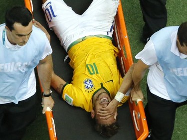 Brazil's forward Neymar is carried off the pitch on a stretcher after being injured during the quarter-final football match between Brazil and Colombia at the Castelao Stadium in Fortaleza during the 2014 FIFA World Cup on July 4, 2014.