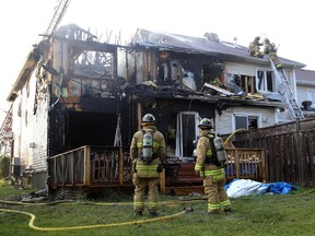Firefighters battle a rowhouse blaze at 109 Abaca Way in Stittsville (Ottawa), Thursday, July 24, 2014. Two townhomes were destroyed and another severely damaged.