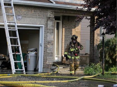 Firefighters battle a rowhouse blaze at 109 Abaca Way in Stittsville (Ottawa), Thursday, July 24, 2014. Two town home were destroyed and another severely damaged.