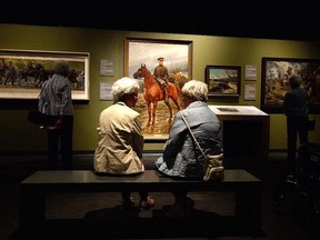 Visitors tour the Witness-Canadian Art From The First World War exhibit at the War Museum on Monday. The exhibit runs until Sept 21.