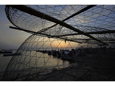 Fishermen load their boats before heading out to sea in Malkiya village, Bahrain, Sunday, July 27, 2014.