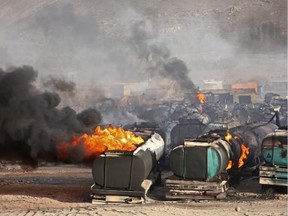 Flames rise from oil tankers after an attack claimed by Taliban militants on the outskirts of Kabul, Afghanistan, Saturday, July 5, 2014. An Afghan security official says at least 400 fuel tankers caught fire late Friday night in a parking lot in the outskirts of Kabul.