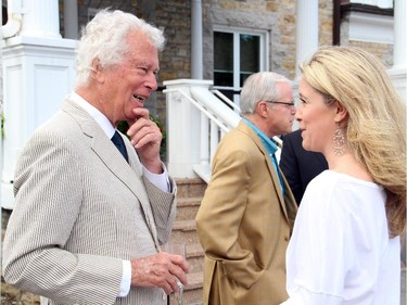 Former Canadian ambassador Ken Taylor chats with TV broadcaster Catherine Clark at the U.S. Embassy's annual Independence Day party, held in Rockcliffe Park on Friday, July 4, 2014.