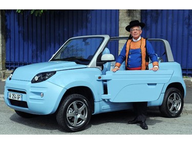 Patrice Bardin, Bluecar's sales manager, poses with the "Blue Summer", the new electric car of French industrial group Bollore, on July 27, 2014 in Quimper, western France.