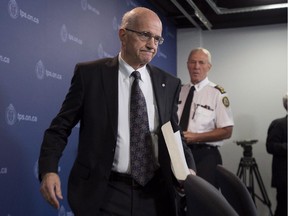 Former Supreme Court of Canada justice Frank Iacobucci, left, and Toronto Police Chief Bill Blair arrive at a press conference at Toronto Police headquarters in Toronto on Thursday, July 24, 2014 to release a report on the investigation into the use of lethal force by Toronto police.
