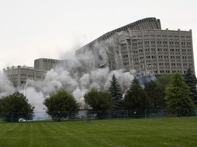 The Sir John Carling building mid implosion on Sunday, July 13, 2014.