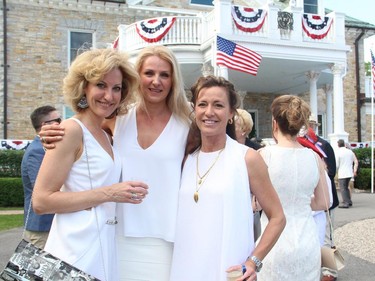 From left are ladies in white, Katharyn Humble, Urszula Kazak and Jennifer Gillespie on Friday, July 4, 2014, at the annual Independence Day party held at the U.S. ambassador's official residence in Rockcliffe.