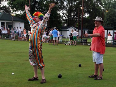 From left, Chad Featherstone clowns around on the greens next to Jake Wright from the opposing team at the Lawn Summer Nights fundraising event held Wednesday, July 2, 2014, at the Elmdale Lawn Bowling Club.