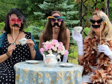 From left, Fiona McKenney, Becky Baxter and Jacqui Hoppin at the garden-setting photo booth set up for the charity tea party for Ryan's Well Foundation, held Sunday, July 20, 2014, in Plaisance, Que.