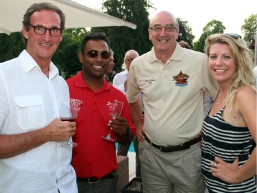 From left, Marc Ouellet with Snowbirds Cpt. Greg Mendes, Vintage Wings pilot Pierre Clément and Nicole Ouellet at the Hadfield Youth Summit Soirée hosted by Michael Potter on Monday, June 30, 2014, in Rockcliffe.