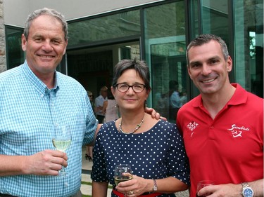 From left, retired Lt.-Gen. Steve Lucas, a former chief of Canada's air force, with his wife, Deb, and Maj. Patrick Gobeil from the Canadian Forces Snowbirds at the Hadfield Youth Summit Soirée held Monday, June 30, 2014, at the Rockcliffe Park home of Michael Potter.