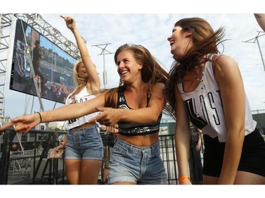 From left:  Sam Tilley, Kate Van Criekengen and Katrina Funk get down to Danny Brown at Bluesfest opening night Thursday, July 3, 2014.