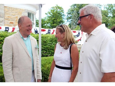 From left, U.S. Ambassador Bruce Heyman greets Ottawa Fire Chief John deHooge and his wife, Heather, at the embassy's annual Fourth of July party held at the ambassador's official residence in Rockcliffe Park on Friday, July 4, 2014.