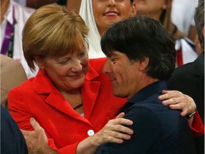 German Chancellor Angela Merkel congratulates head coach Joachim Loew of Germany after defeating Argentina 1-0 in extra time during the 2014 FIFA World Cup Brazil Final match between Germany and Argentina.