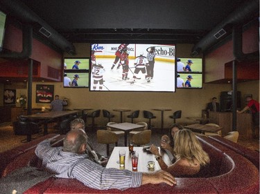Guest enjoy the big screen during a ceremonial grand opening of Sens House, the official sports bar of the Ottawa Senators, in the Byward Mark at 73 York St. Thursday, July 24, 2014.