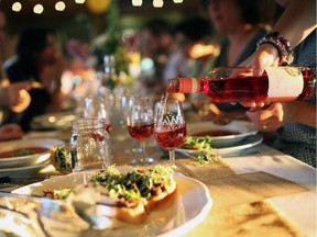 Guests talk and enjoy wine at Saunders Farm's first Farm Fresh family-style gourmet dinner, held July 24, 2014.