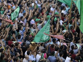 Hamas supporters shout slogans against the Israeli military action in Gaza, during a demonstration in the West Bank city of Nablus, Thursday, July 31, 2014.