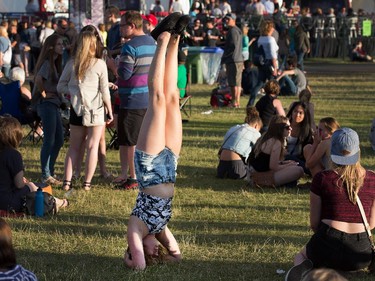 Hannah Sparling does a handstand while waiting for the next band to play at Bluesfest.