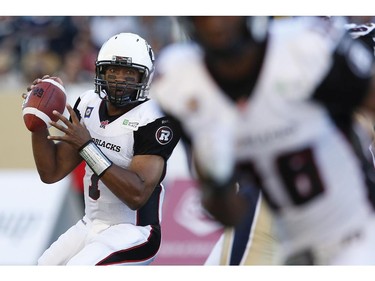 Ottawa Redblacks quarterback Henry Burris (1) gets set to throw against the Winnipeg Blue Bombers during the first half of CFL action in Winnipeg Thursday, July 3, 2014.