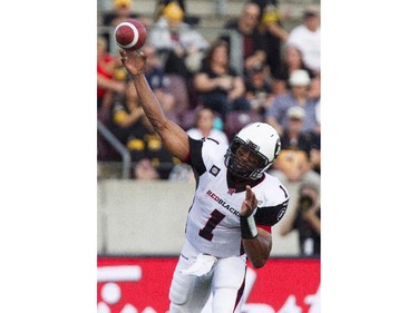 Ottawa RedBlacks quarterback Henry Burris makes a pass in first quarter CFL action against the Hamilton Tiger-Cats in Hamilton, Ont., Saturday, July 26, 2014.
