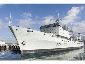 The Royal Canadian ship HMCS Protecteur is towed into Joint Base Pearl Harbor-Hickam after suffering an engine fire aboard the ship while at sea, Thursday, March 6, 2014, in Honolulu.  The ship got help from the U.S. Navy after the fire broke out last week, leaving 20 sailors with minor injuries, the Royal Canadian Navy said.