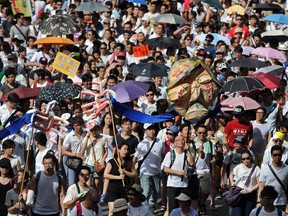 This photo taken on July 1, 2014 shows protesters marching during a pro-democracy rally seeking greater democracy in Hong Kong.