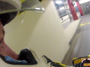 A screen capture from the YouTube video that shows a motorcyclist riding through the underground walkway at Carleton University.