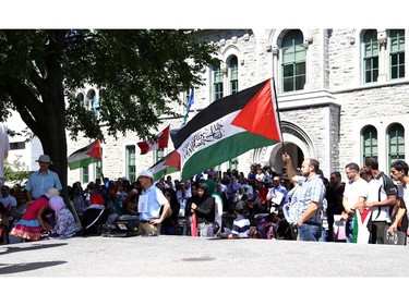 Hundreds gathered in support of Palestine at the Human Rights Memorial in Ottawa, Saturday, July 12, 2014. Many brought banners and flags, and chanted, and later, they marched toward another rally in front of the US embassy on Sussex Dr.