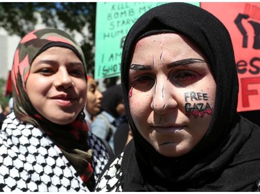 Hundreds of people gathered in support of Palestine at the Human Rights Memorial in Ottawa, Saturday, July 12, 2014. Many brought banners and flags, and chanted, and later, they marched toward another rally in front of the US embassy on Sussex Dr.