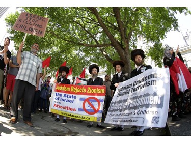 Hundreds of people rally in support of Palestine at the Human Rights Memorial in Ottawa, Saturday, July 12, 2014. Many brought banners and flags, and chanted, and later, they marched up Elgin St. toward another rally in front of the US embassy on Sussex Dr.