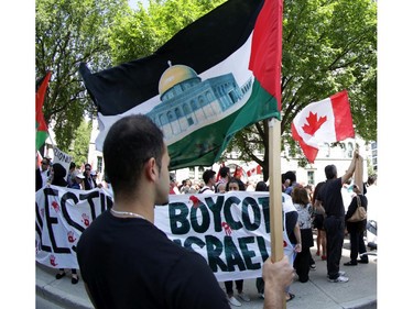 Hundreds of people rally in support of Palestine at the Human Rights Memorial in Ottawa, Saturday, July 12, 2014. Many brought banners and flags, and chanted, and later, they marched toward another rally in front of the US embassy on Sussex Dr.