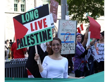 Hundreds rally in support of Palestine at the Human Rights Memorial in Ottawa, Saturday, July 12, 2014. Many brought banners and flags, and chanted, and later, they marched toward another rally in front of the US embassy on Sussex Dr.