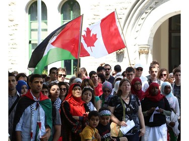 Hundreds rally in support of Palestine at the Human Rights Memorial in Ottawa, Saturday, July 12, 2014. Many brought banners and flags, and chanted, and later, they marched toward another rally in front of the US embassy on Sussex Dr.