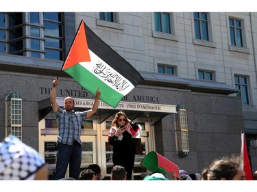 Hundreds rally in support of Palestine outside the US embassy in Ottawa, Saturday, July 12, 2014. Many brought banners and flags, in a protest march that began at 2pm at the Human Rights Memorial on Elgin St.