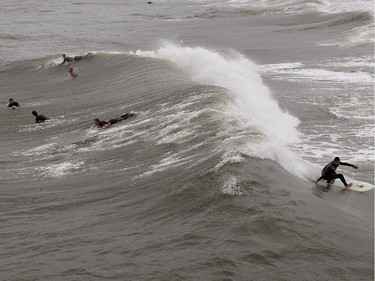 Surfers take advantage of the large waves left by Hurricane Arthur, July 4, 2014 in Avalon, North Carolina. Hurricane Arthur hit North Carolina's outer banks overnight causing widespread power outages, flooding and damage, and has since weakened to a Category 1 as of Friday morning.